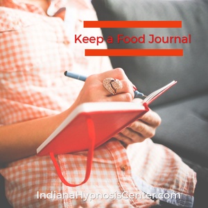 Woman writing in a food journal - Indiana Hypnosis Center